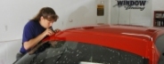 Young Lady installing Windshield Strip